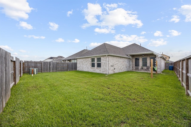 15603 Beltie Dr, Humble, TX 77346 - rear view of property featuring roof with shingles, brick siding, and a fenced backyard