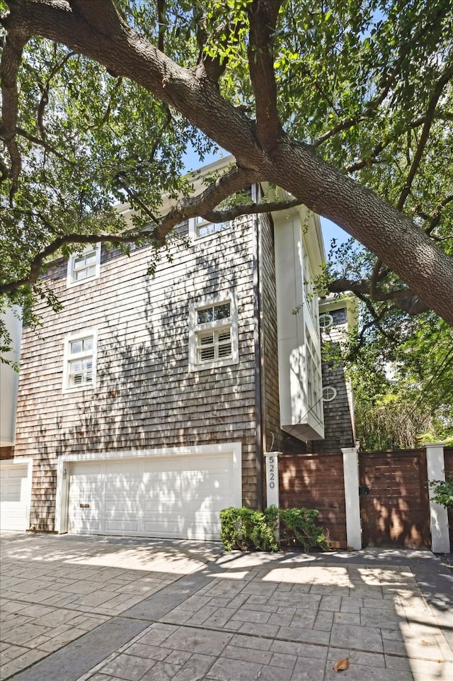 5220 Hazard St, Houston, TX 77098 - view of home's exterior with an attached garage and concrete driveway