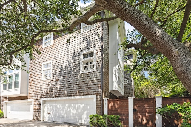 5220 Hazard St, Houston, TX 77098 - view of property exterior with an attached garage and concrete driveway