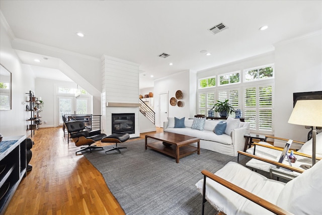 5220 Hazard St, Houston, TX 77098 - living room featuring ornamental molding, wood finished floors, recessed lighting, and a fireplace