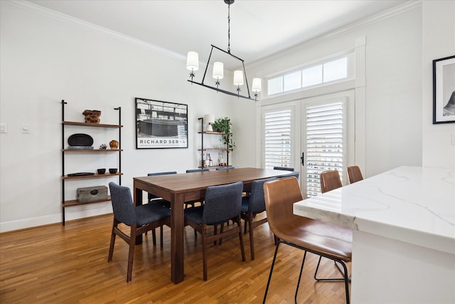 5220 Hazard St, Houston, TX 77098 - dining area with light wood-style floors, ornamental molding, and a chandelier
