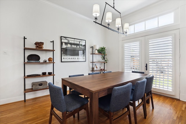 5220 Hazard St, Houston, TX 77098 - dining room featuring crown molding, wood finished floors, and a chandelier