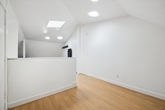 5220 Hazard St, Houston, TX 77098 - additional living space with a skylight, lofted ceiling, and wood finished floors