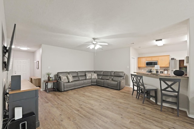 15010 Sunset Villa Ct, Humble, TX 77396 - living area with a ceiling fan and light wood-style floors