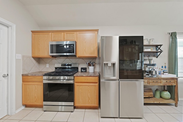 15010 Sunset Villa Ct, Humble, TX 77396 - kitchen featuring appliances with stainless steel finishes, tasteful backsplash, light tile patterned flooring, light brown cabinets, and lofted ceiling