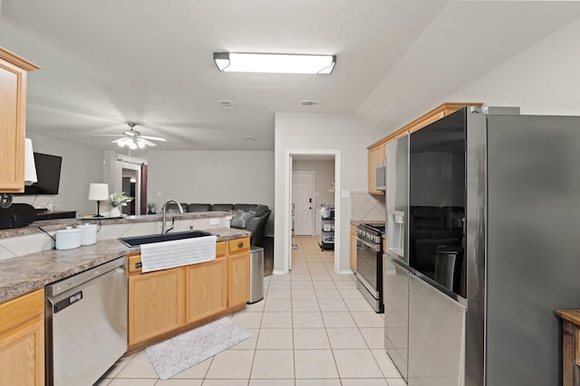 15010 Sunset Villa Ct, Humble, TX 77396 - kitchen featuring stainless steel appliances, open floor plan, light brown cabinetry, and light tile patterned flooring