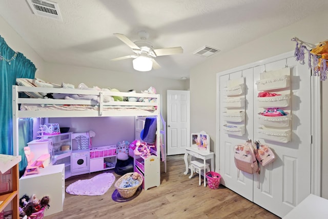 15010 Sunset Villa Ct, Humble, TX 77396 - bedroom with wood finished floors, a ceiling fan, and a closet