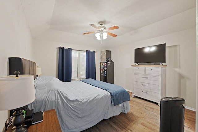 15010 Sunset Villa Ct, Humble, TX 77396 - bedroom with wood finished floors, a tray ceiling, and a ceiling fan
