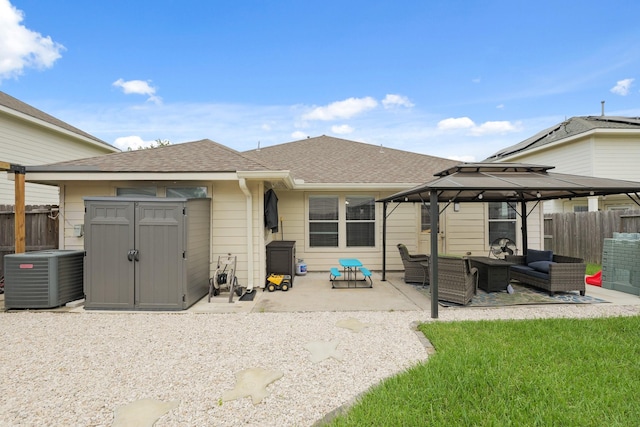 15010 Sunset Villa Ct, Humble, TX 77396 - back of property with an outdoor hangout area, a gazebo, a patio area, and a fenced backyard
