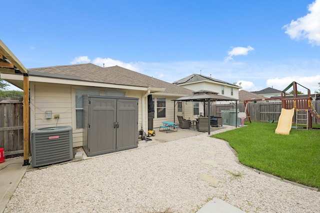 15010 Sunset Villa Ct, Humble, TX 77396 - rear view of house with a gazebo, a playground, a fenced backyard, a patio area, and a storage shed