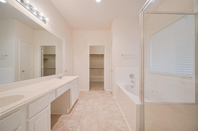 17134 Fairway Glen Ct, Sugar Land, TX 77498 - bathroom featuring double vanity, a walk in closet, a bath, recessed lighting, and tile patterned floors