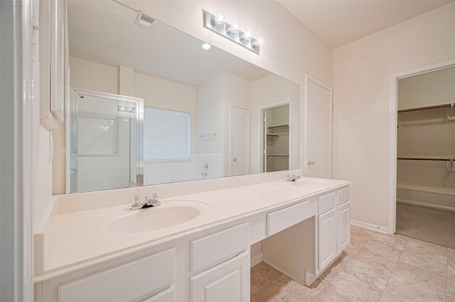 17134 Fairway Glen Ct, Sugar Land, TX 77498 - bathroom with a spacious closet, double vanity, and a shower stall