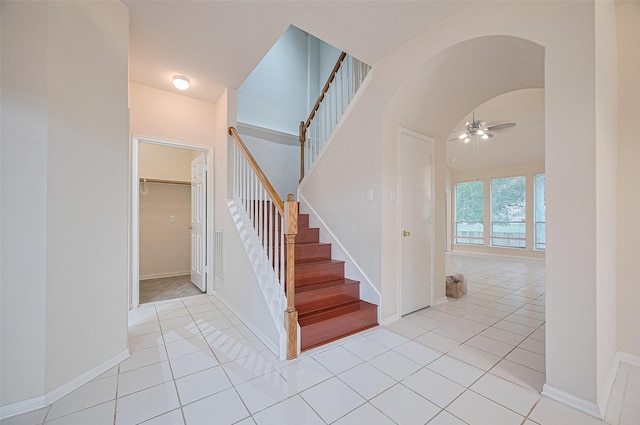 17134 Fairway Glen Ct, Sugar Land, TX 77498 - stairs featuring a ceiling fan, tile patterned floors, and arched walkways