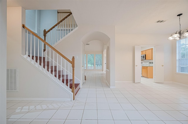17134 Fairway Glen Ct, Sugar Land, TX 77498 - foyer featuring healthy amount of natural light, a chandelier, stairs, and arched walkways