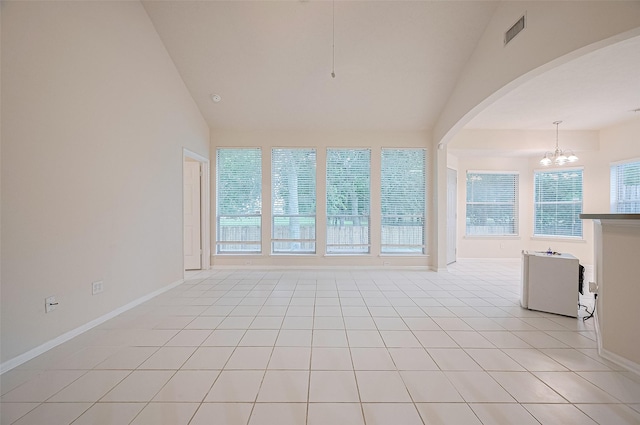17134 Fairway Glen Ct, Sugar Land, TX 77498 - unfurnished living room with a chandelier, arched walkways, light tile patterned flooring, and high vaulted ceiling