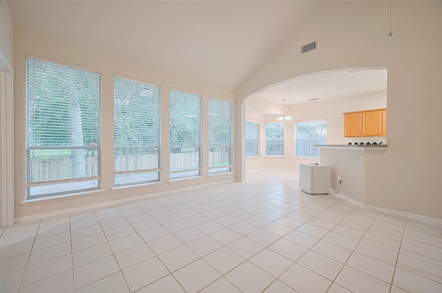 17134 Fairway Glen Ct, Sugar Land, TX 77498 - unfurnished room featuring arched walkways, a chandelier, vaulted ceiling, and light tile patterned floors