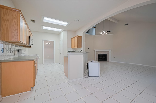17134 Fairway Glen Ct, Sugar Land, TX 77498 - kitchen featuring a ceiling fan, open floor plan, light tile patterned floors, white electric range oven, and stainless steel microwave