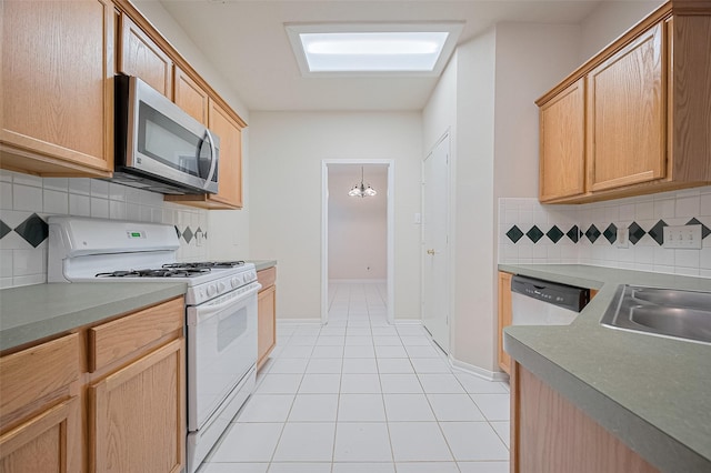 17134 Fairway Glen Ct, Sugar Land, TX 77498 - kitchen with appliances with stainless steel finishes, light tile patterned flooring, backsplash, and light brown cabinets