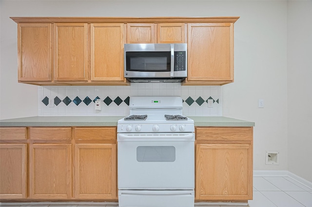 17134 Fairway Glen Ct, Sugar Land, TX 77498 - kitchen featuring stainless steel microwave, white gas stove, tasteful backsplash, and light countertops