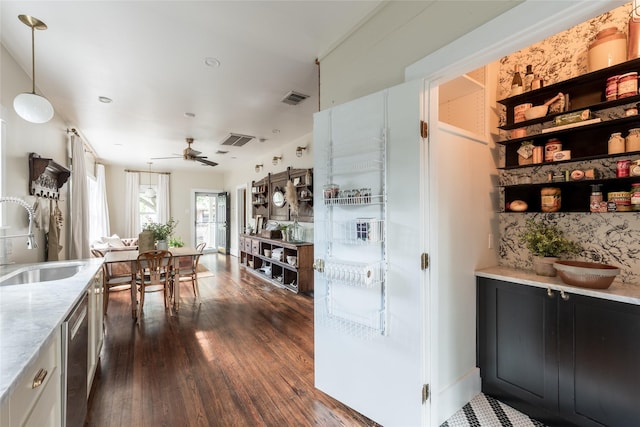 108 E 27th St, Houston, TX 77008 - kitchen featuring dark wood-style flooring, dishwasher, light stone countertops, ceiling fan, and decorative light fixtures