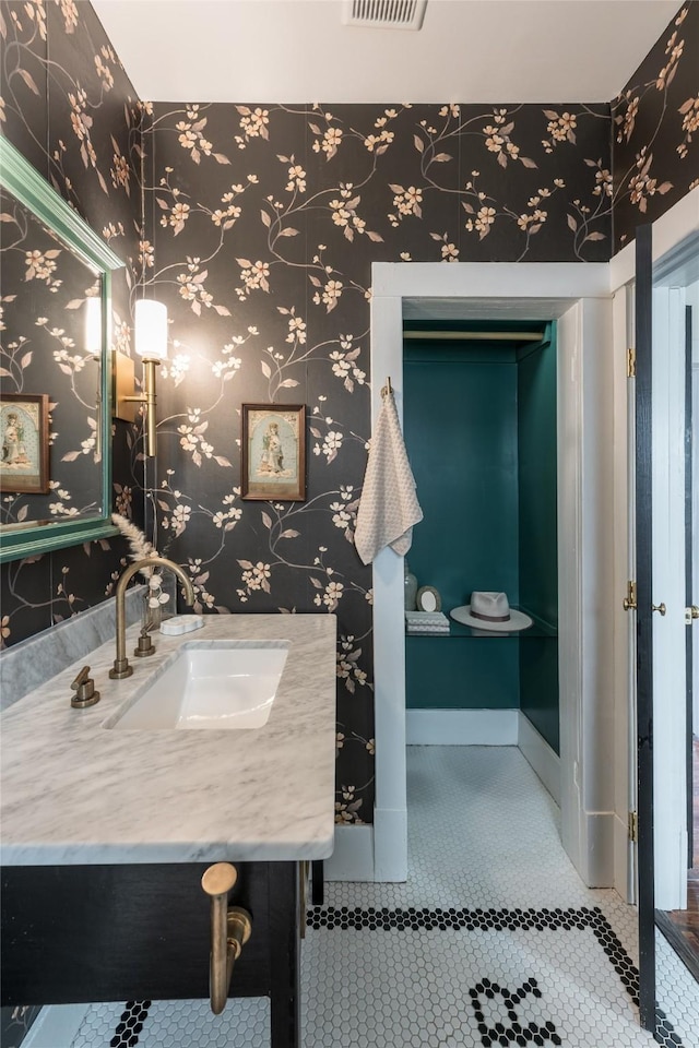 108 E 27th St, Houston, TX 77008 - bathroom with wallpapered walls, tile patterned floors, and vanity
