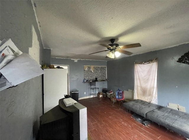 122 Amundsen St, Houston, TX 77009 - living room featuring wood finished floors, a textured ceiling, and ceiling fan