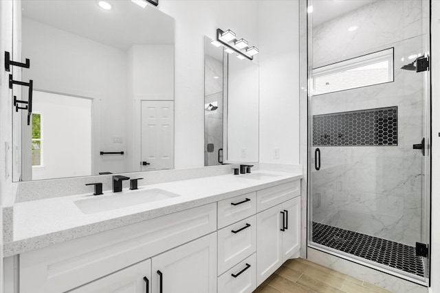 213 N 7th St, La Porte, TX 77571 - bathroom featuring a marble finish shower, double vanity, wood finished floors, and recessed lighting