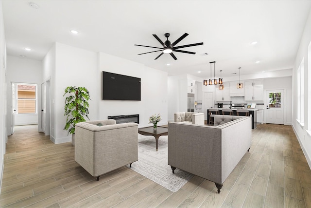 213 N 7th St, La Porte, TX 77571 - living area with ceiling fan, light wood-type flooring, recessed lighting, and a glass covered fireplace