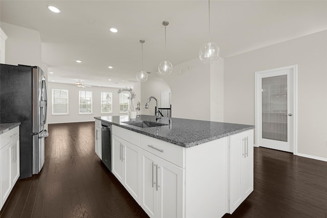 1909 Monaco Memorial Ln, Houston, TX 77043 - kitchen featuring appliances with stainless steel finishes, dark wood finished floors, a ceiling fan, dark stone countertops, and recessed lighting