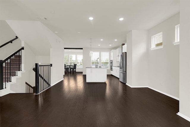 1909 Monaco Memorial Ln, Houston, TX 77043 - kitchen featuring freestanding refrigerator, white cabinetry, dark wood-style flooring, a kitchen island, and recessed lighting