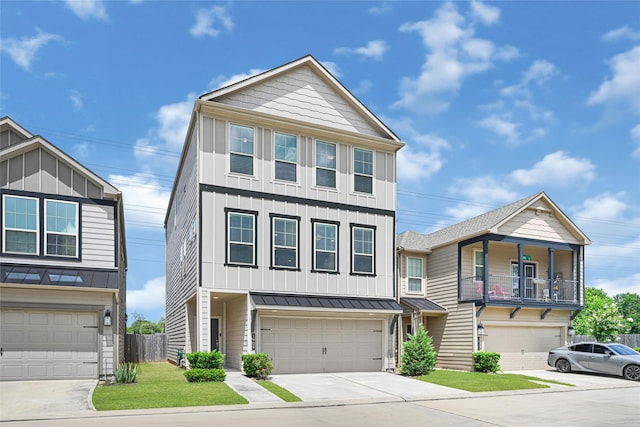 1909 Monaco Memorial Ln, Houston, TX 77043 - view of front facade with board and batten siding, an attached garage, a standing seam roof, and driveway