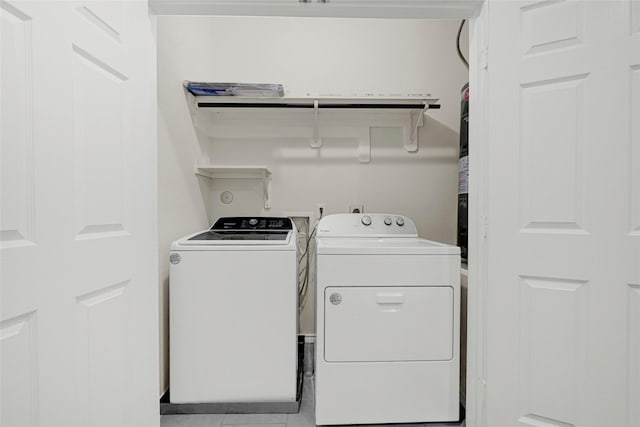 1909 Monaco Memorial Ln, Houston, TX 77043 - washroom with washing machine and dryer and tile patterned flooring