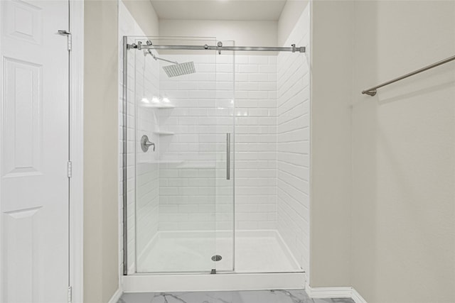 1909 Monaco Memorial Ln, Houston, TX 77043 - bathroom featuring marble look tile flooring and a shower stall