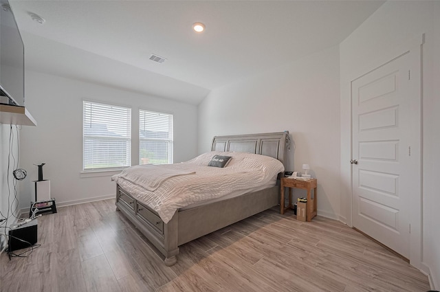 3918 Beltingham Bend Way, Fulshear, TX 77441 - bedroom featuring light wood-type flooring and vaulted ceiling