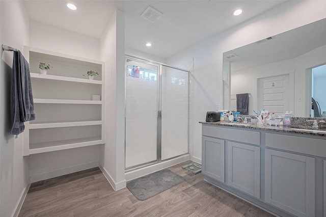 3918 Beltingham Bend Way, Fulshear, TX 77441 - full bathroom featuring a stall shower, double vanity, wood finished floors, and recessed lighting