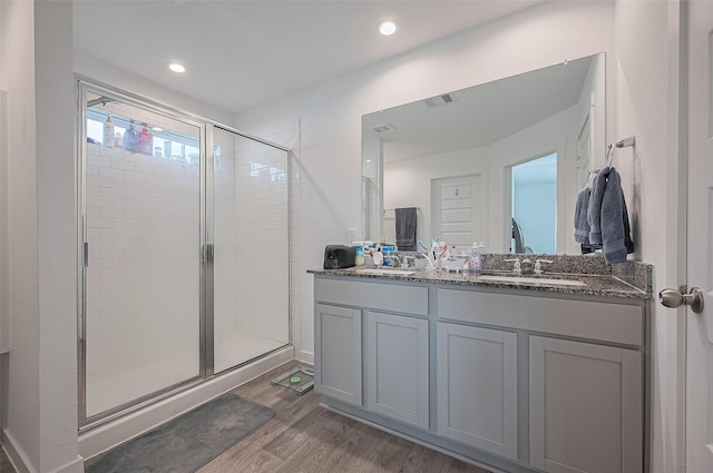 3918 Beltingham Bend Way, Fulshear, TX 77441 - bathroom featuring wood finished floors, a shower stall, double vanity, and recessed lighting