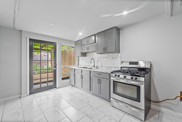 16310 Mulberry Run Ct, Sugar Land, TX 77498 - kitchen featuring stainless steel gas range, gray cabinets, light marble finish flooring, and recessed lighting