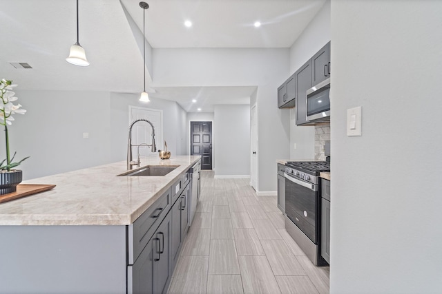 16310 Mulberry Run Ct, Sugar Land, TX 77498 - kitchen featuring appliances with stainless steel finishes, gray cabinetry, hanging light fixtures, decorative backsplash, and recessed lighting
