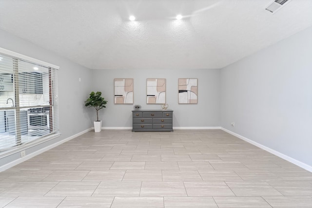 16310 Mulberry Run Ct, Sugar Land, TX 77498 - empty room with baseboards and a textured ceiling