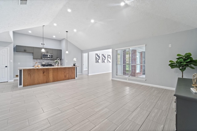 16310 Mulberry Run Ct, Sugar Land, TX 77498 - kitchen with appliances with stainless steel finishes, open floor plan, vaulted ceiling, a textured ceiling, and light countertops
