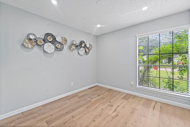 16310 Mulberry Run Ct, Sugar Land, TX 77498 - empty room featuring light wood-style flooring, a textured ceiling, and recessed lighting