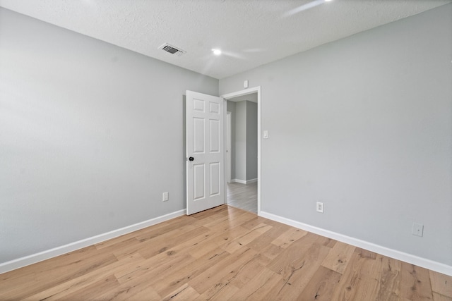16310 Mulberry Run Ct, Sugar Land, TX 77498 - spare room featuring light wood-style flooring and a textured ceiling