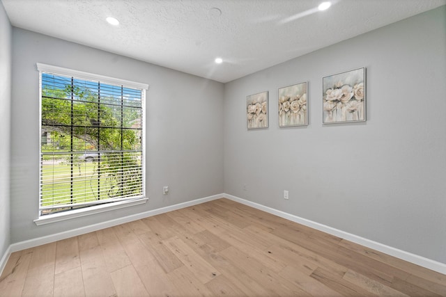 16310 Mulberry Run Ct, Sugar Land, TX 77498 - empty room featuring recessed lighting, light wood finished floors, and a textured ceiling