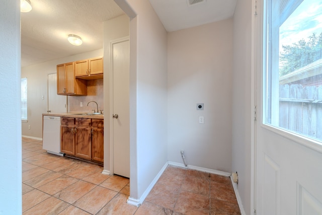 20027 Oland Way, Houston, TX 77073 - washroom featuring electric dryer hookup, plenty of natural light, and light tile patterned flooring