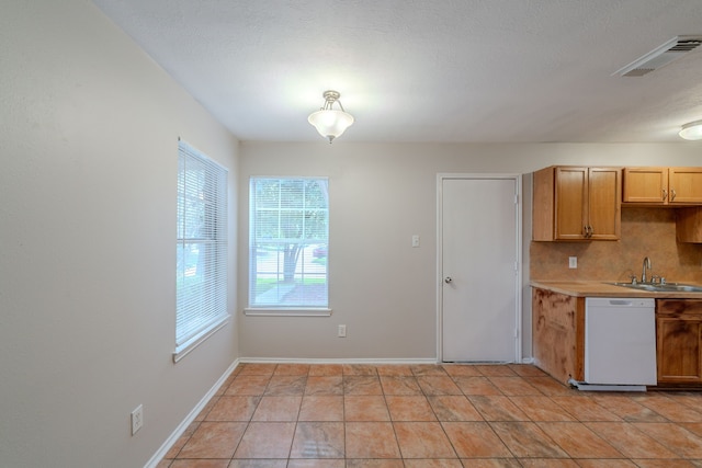 20027 Oland Way, Houston, TX 77073 - kitchen featuring dishwasher, light countertops, decorative backsplash, and light tile patterned floors