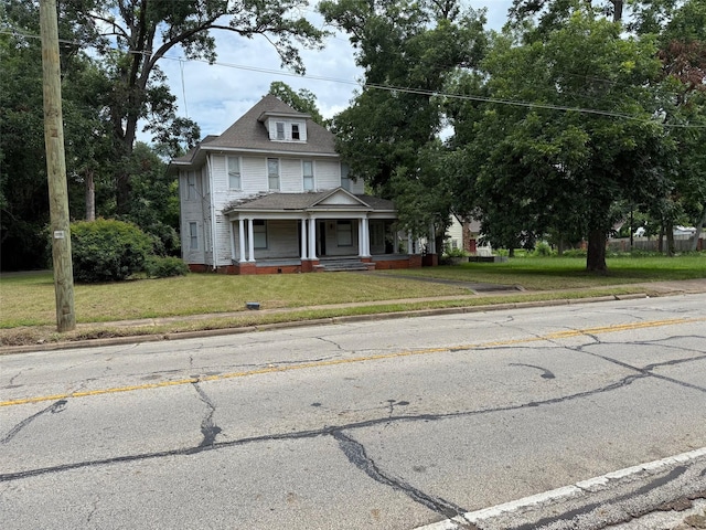 906 E Houston Ave, Crockett, TX 75835 - view of front of house featuring a porch, a front yard, and roof with shingles