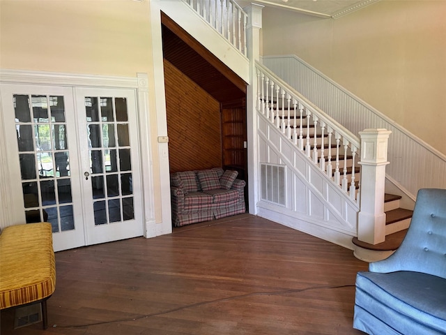 906 E Houston Ave, Crockett, TX 75835 - staircase with french doors, wood-type flooring, and a wainscoted wall