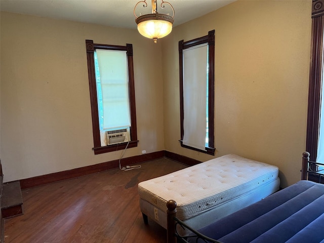 906 E Houston Ave, Crockett, TX 75835 - bedroom with dark wood finished floors and cooling unit
