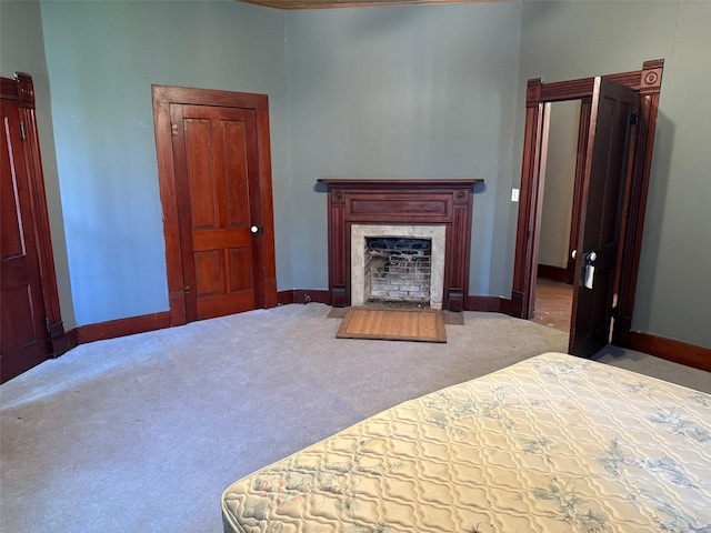 906 E Houston Ave, Crockett, TX 75835 - carpeted bedroom with a high end fireplace and baseboards