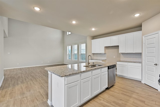 160 Majestic Shores Ln, La Porte, TX 77571 - kitchen with stainless steel dishwasher, light wood finished floors, decorative backsplash, white cabinets, and recessed lighting